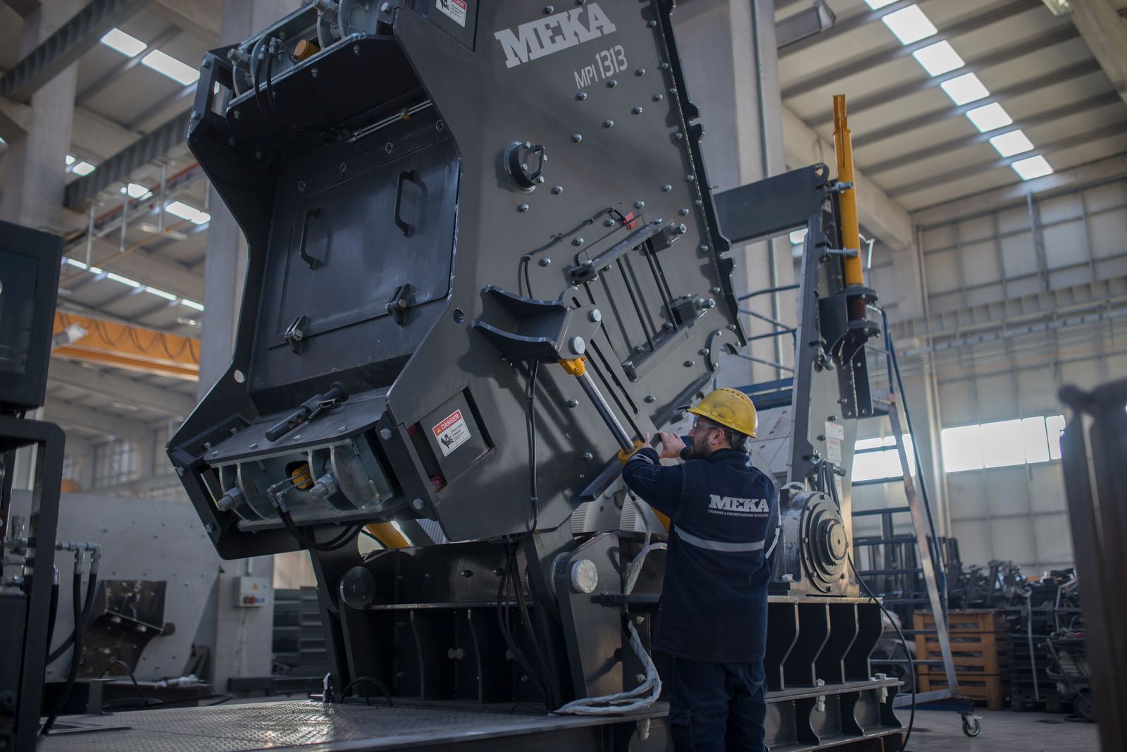 Technicians assembling a large industrial crushing machine
