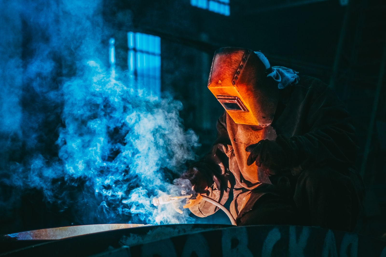 Welder at work amid sparks in the Manufacturing Stars facility