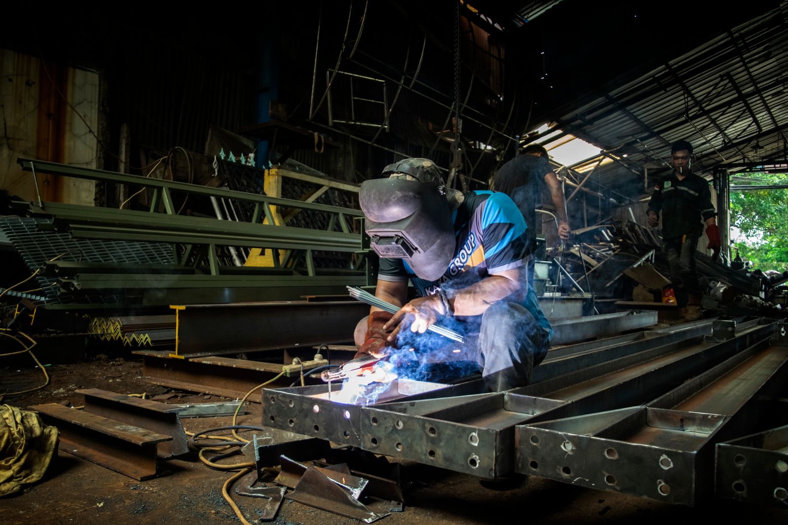 Welders fabricating a large structural steel assembly