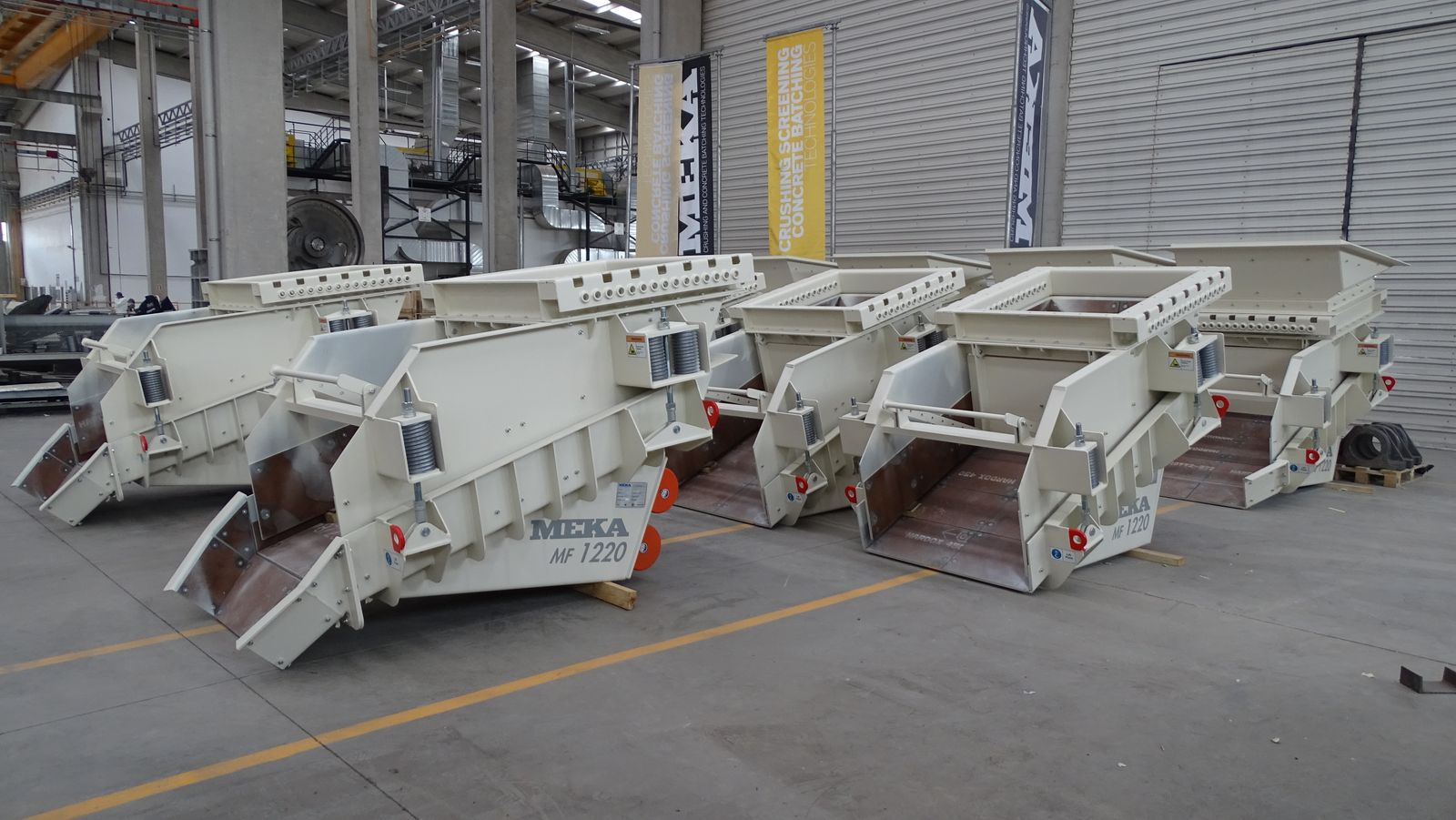 Finished heavy equipment units staged for coating and shipment